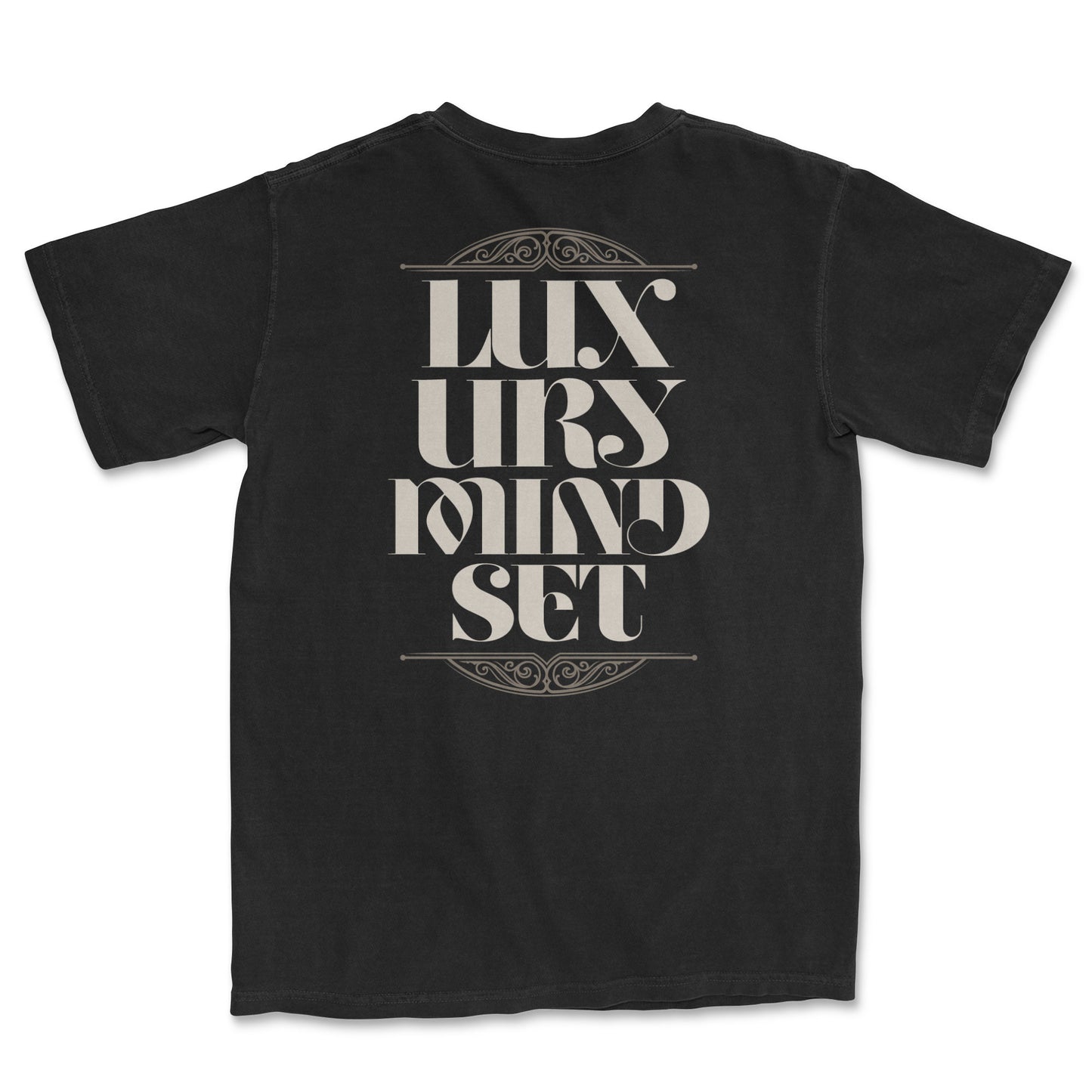 Back of a black t-shirt with large, ornate beige text that reads "LUXURY MINDSET." The text is framed by decorative, swirling line art above and below it.
