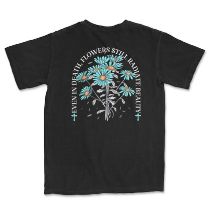 Image of a black t-shirt with a flower design and the quote " Even in death flowers still radiate beauty".