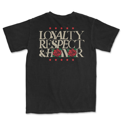 Back of a black t-shirt featuring the words "LOYALTY RESPECT & HONOR" in a distressed, light-colored font. Red stars are above and below the text, and two red rose graphics replace the "O"s in "HONOR. T-shirt by PSTVE Brand