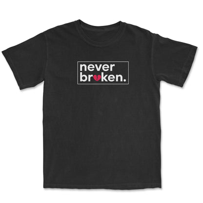 Black t-shirt with the phrase "never broken." printed on the chest. The word "broken" is inside a white rectangle, and a distressed red heart is within the word.