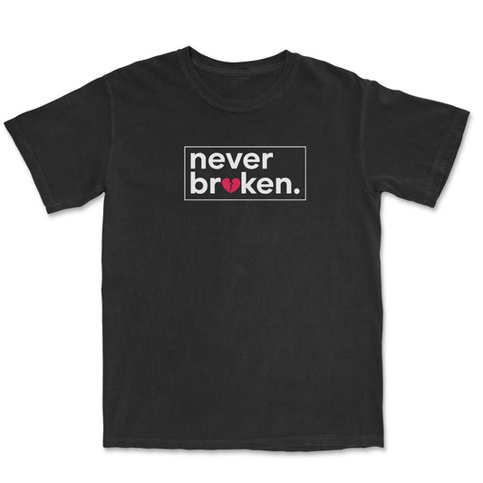 Black t-shirt with the phrase "never broken." printed on the chest. The word "broken" is inside a white rectangle, and a distressed red heart is within the word.