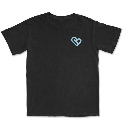 Front view of a black t-shirt with a small, light blue heart outline on the left chest - PSTVE Brand